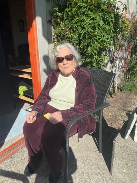 Marlene seated outdoors in the sun
